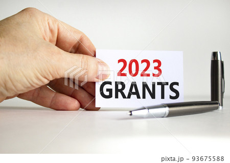 2023 Grants symbol. White paper with words 2023 Grants. Businessman hand. Metallic pen. Beautiful white table white background. Business and 2023 grants concept. Copy space. 2023 Grants symbol. White paper with words 2023 Grants. Businessman hand. Metallic pen. Beautiful white table white background. Business and 2023 grants concept. Copy space. 93675588