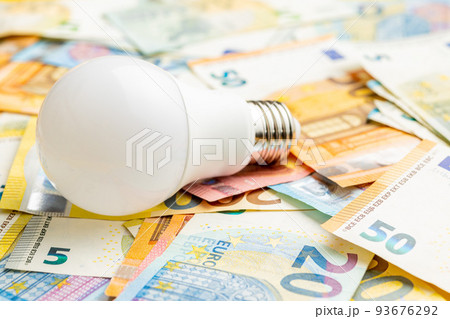 Light bulb and euro money. Concept of increasing electricity prices. Light bulb and euro money. Concept of increasing electricity prices. 93676292