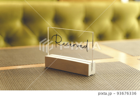 Reserve table dinner. A plate for reserving a table in a restaurant for an evening dinner Reserve table dinner. A plate for reserving a table in a restaurant for an evening dinner 93676336