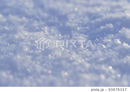 Snowy texture background and snow surface in winter under the sun on a clear frosty day. 93676337