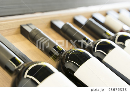 Wine bottles with blank labels on the counter of a liquor store. Wine background. Selected focus 93676338