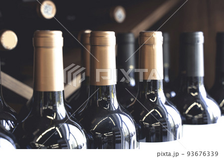 Wine bottles with blank labels on the counter of a liquor store. Wine background. Selected focus 93676339