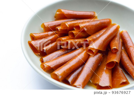 Dried mango paste sheets on white background. 93676927