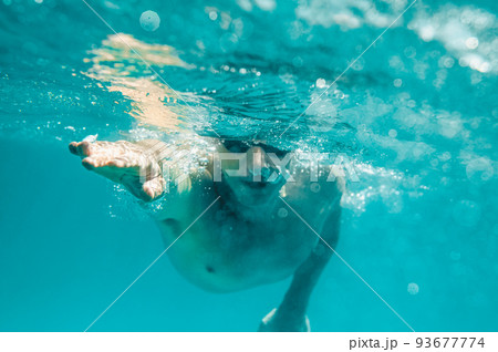 Sporty man swims fast in the sea Sporty man swims fast in the sea 93677774