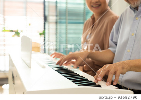Elderly senior couple play Piano music together. Group of Two Asian smart mature Person retire and get pension fund. Grandparent express feeling happy treatment. Concept grow old together, copy space Elderly senior couple play Piano music together. Group of Two Asian smart mature Person retire and get pension fund. Grandparent express feeling happy treatment. Concept grow old together, copy space 93682790