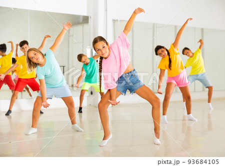 Group of kids training modern dance moves Group of kids training modern dance moves 93684105