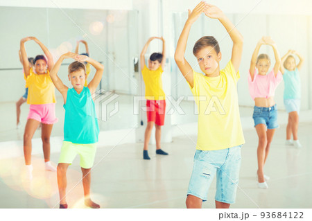 Group of kids training dance moves Group of kids training dance moves 93684122