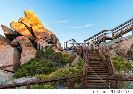 Tourists walking trail on Granite Island at sunset 93687453