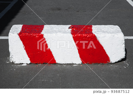 Red white road block made of concrete 93687512