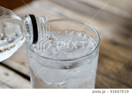 ペットボトルの炭酸水をグラスに注いでいるところ 93687619