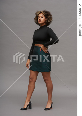 Young gorgeous female fashion model wearing cropped top and mini skirt 93688812