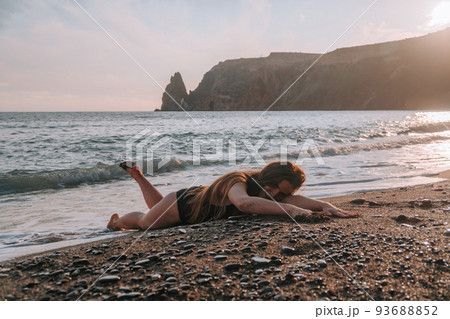 Selective focus. Happy carefree sensual woman with long hair in black swimwear posing at sunset beach. Silhouette of young beautiful playful positive woman outdoor. Summer vacation and trip concept Selective focus. Happy carefree sensual woman with long hair in black swimwear posing at sunset beach. Silhouette of young beautiful playful positive woman outdoor. Summer vacation and trip concept 93688852