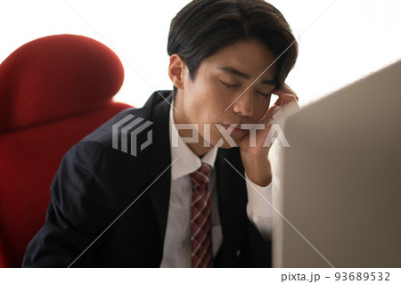 オフィスで仕事に疲れる若いビジネスマン オフィスで仕事に疲れる若いビジネスマン 93689532