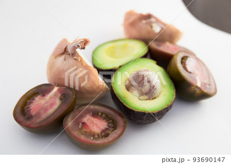 vegetables black tomatoes, avocado and onions on white background vegetables black tomatoes, avocado and onions on white background 93690147