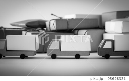 トラックの列と荷物　流通センターを出る宅配トラックの列　繁忙期　配送の小包　ドライバー不足 93698321