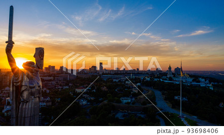 Aerial view to the Motherland statue in the Kiev while  summer sunset. The well-known landmarks in Kyiv. Historical monument of Soviet union. Beautiful city Kiev while sunset. 93698406