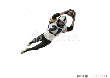 Portrait of american football player in motion, catching ball in a jump isolated over white background. Concentration 93698531