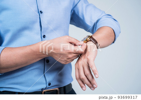 Setting clock going. Man wind wrist watch grey background. Portable timepiece. Time management. Deadline. Clock is ticking 93699317