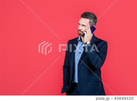 mature ambitious man businessman in businesslike suit talk on phone, copy space, negotiation mature ambitious man businessman in businesslike suit talk on phone, copy space, negotiation 93699320