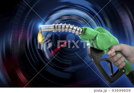 Holding a fuel injector against a speedometer on a blurred background 93699609