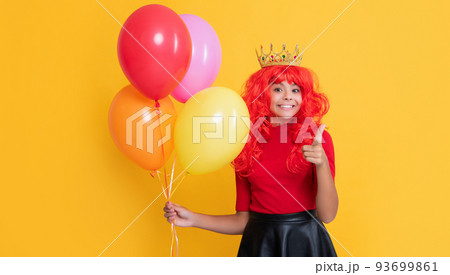 happy child in crown with party balloon on yellow background happy child in crown with party balloon on yellow background 93699861