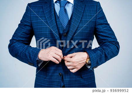 Buttoning up male vested blue suit with tie in formal fashion style grey background, formalwear 93699952