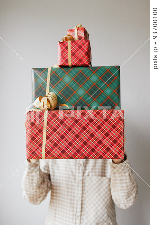 woman is holding boxes with gifts for Christmas, new year or birthday. Women's hands put give gifts 93700100