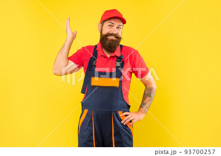 smiling funny bearded man technician in work clothes on yellow background smiling funny bearded man technician in work clothes on yellow background 93700257