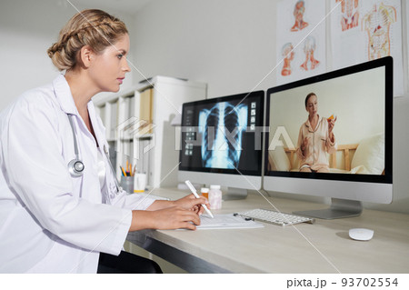General practitioner talking to sick patient and writing down complains General practitioner talking to sick patient and writing down complains 93702554