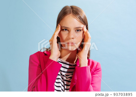 Studio shot of young charming girl posing isolated over blue background. Concept of emotions, mental health, art and youth 93703895