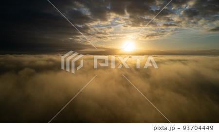 Aerial View. Flying in fog, fly in mist over the early morning clouds in the rising sun. Aerial 93704449