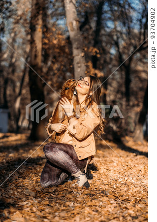 Improving Dogs Immune System. Boost puppy Immune System. Happy woman walking with cocker spaniel puppy in autumn park 93704902