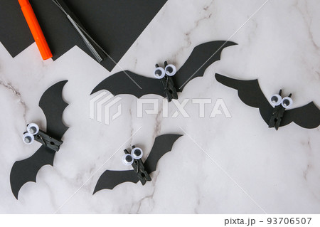 Paper bats. Halloween holiday decorations. Flat lay, top view Happy Halloween party concept. Children's art project. DIY concept. Step by step Paper bats. Halloween holiday decorations. Flat lay, top view Happy Halloween party concept. Children's art project. DIY concept. Step by step 93706507