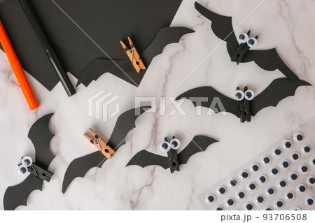 Paper bats. Halloween holiday decorations. Flat lay, top view Happy Halloween party concept. Children's art project. DIY concept. Step by step Paper bats. Halloween holiday decorations. Flat lay, top view Happy Halloween party concept. Children's art project. DIY concept. Step by step 93706508