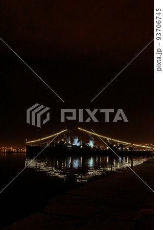 Night view of moored WW2 Greek warship against dark sky. Night view of moored WW2 Greek warship against dark sky. 93706745