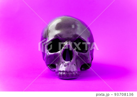 Halloween holiday concept. Scary skull on purple background. Selective focus Halloween holiday concept. Scary skull on purple background. Selective focus 93708136