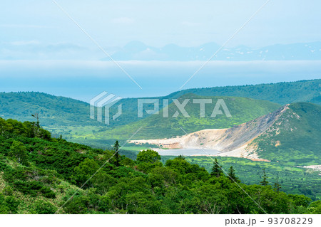 landscape of Kunashir Island, geothermal lakes among lava domes in the center of Golovnin volcano caldera; the island of Hokkaido is visible in the distance in the sea landscape of Kunashir Island, geothermal lakes among lava domes in the center of Golovnin volcano caldera; the island of Hokkaido is visible in the distance in the sea 93708229
