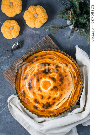 Ready-to-eat fresh sweet layered pumpkin pie in the form on the table. Thanksgiving treat. Top and vertical view 93709325