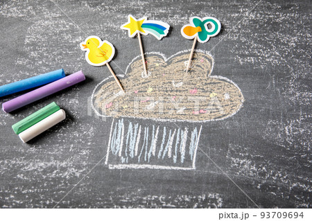 Holiday and birthday concept. Colored pieces of chalk on a blackboard background 93709694