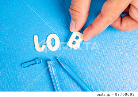 JOB. Text from white wooden letters on a blue background JOB. Text from white wooden letters on a blue background 93709695