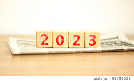 2023 happy new year symbol. Wooden cubes on newspaper symbolize the change from 2022 to the new year 2023. Beautiful white background. Copy space. Business and 2023 happy new year concept. 2023 happy new year symbol. Wooden cubes on newspaper symbolize the change from 2022 to the new year 2023. Beautiful white background. Copy space. Business and 2023 happy new year concept. 93709928