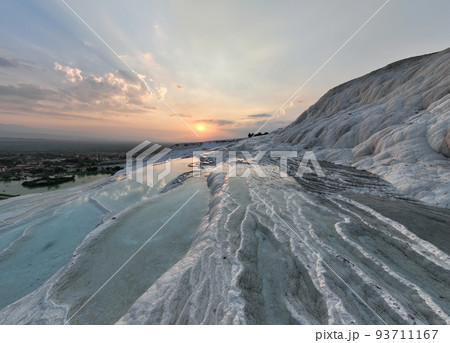 Pamukkale Travertines Cinematic Aerial Drone footage. Turkish famous white thermal bath with healthy clean water in a beautiful sunset.  93711167