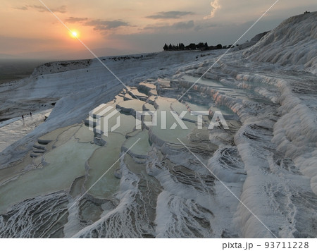 Pamukkale Travertines Cinematic Aerial Drone footage. Turkish famous white thermal bath with healthy clean water in a beautiful sunset.  93711228