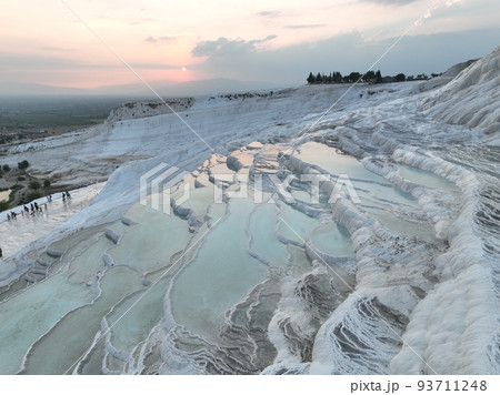 Pamukkale Travertines Cinematic Aerial Drone footage. Turkish famous white thermal bath with healthy clean water in a beautiful sunset. Pamukkale Travertines Cinematic Aerial Drone footage. Turkish famous white thermal bath with healthy clean water in a beautiful sunset. 93711248