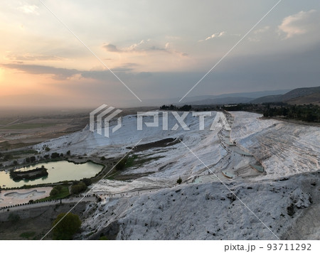 Pamukkale Travertines Cinematic Aerial Drone footage. Turkish famous white thermal bath with healthy clean water in a beautiful sunset.  93711292