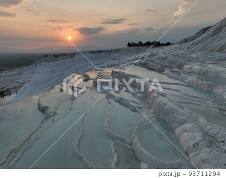 Pamukkale Travertines Cinematic Aerial Drone footage. Turkish famous white thermal bath with healthy clean water in a beautiful sunset.  93711294
