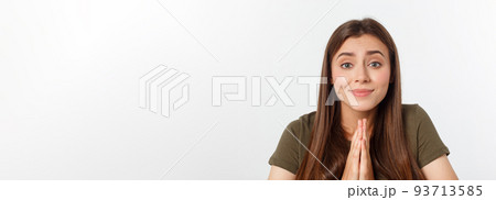 Beautiful young woman in casual clothes holding hands together and praying, isolated on white. Beautiful young woman in casual clothes holding hands together and praying, isolated on white. 93713585