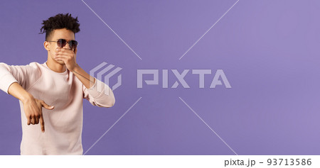Waist-up portrait of cool young handsome guy with dreads, sunglasses on, hold hand over mouth while beatboxing, waving hand to shake audience up, reading own rap, purple background Waist-up portrait of cool young handsome guy with dreads, sunglasses on, hold hand over mouth while beatboxing, waving hand to shake audience up, reading own rap, purple background 93713586