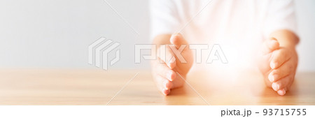 Insurance concept. Light between man hands in gesture of protection and blank space 93715755