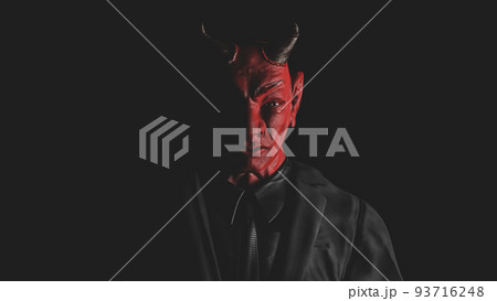 Appearance of red devil from the darkness. light from the side. 93716248